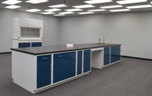 16' x 4' blue laboratory cabinets with black countertop and sink.
