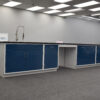 16' blue laboratory cabinets with desk cutout and sink.