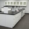 16' x 4' white laboratory cabinets island. Cabinets and drawers are on both sides of the island.