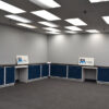 18'x19' blue L-shaped laboratory cabinets with two desk cutouts and sink.