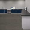 Side view of 18'x19' blue L-shaped laboratory cabinets with desk cutout