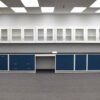 Direct view of 19 feet of blue laboratory cabinets with 19 feet of white wall units. Desk cutout included.
