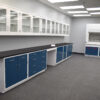 Angled view of 19 feet of blue laboratory cabinets with 19 feet of white wall units.