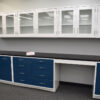 19 feet of blue laboratory cabinets with 19 feet of white wall units. Desk cutout included.